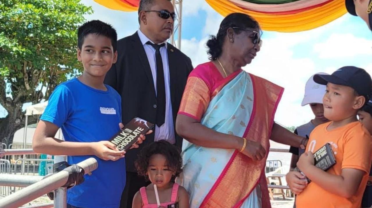Despite her many official engagements, President Droupadi Murmu spent some time with a group of children who came to greet her in Paramaribo. She offered them India-made chocolates