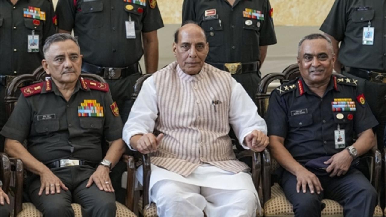 Defence Minister Rajnath Singh flanked by Chief of Army Staff General Manoj Pande, right, and Chief of Defence Staff of the Indian Armed Forces Anil Chauhan at the 75th anniversary event of ‘UN Peacekeepers Day’