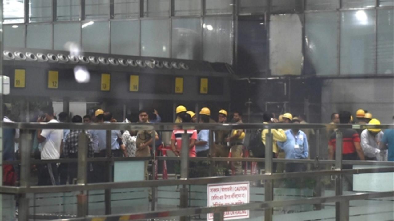 Firemen and other officials at the departure gate of Netaji Subhash Chandra Bose International Airport where a fire broke out