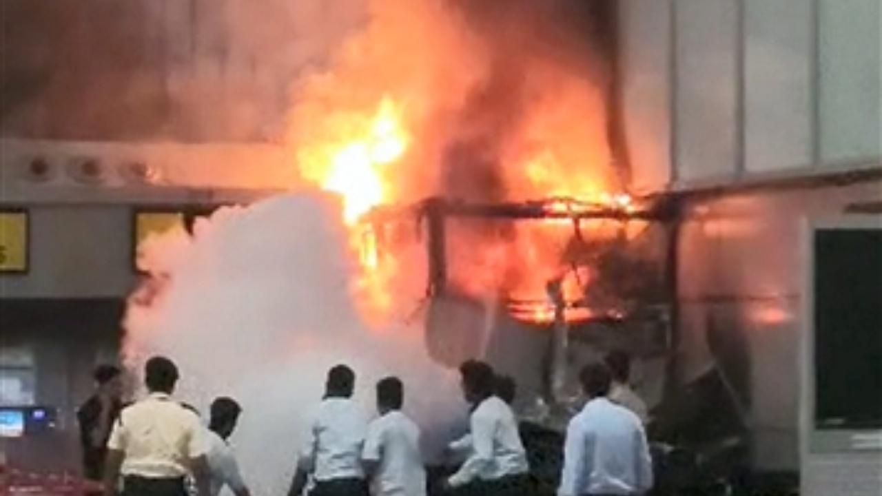 Airport officials try to douse a fire breaking out near a departure gate of the Netaji Subhas Chandra Bose International Airport, in Kolkata (Pic/PTI)