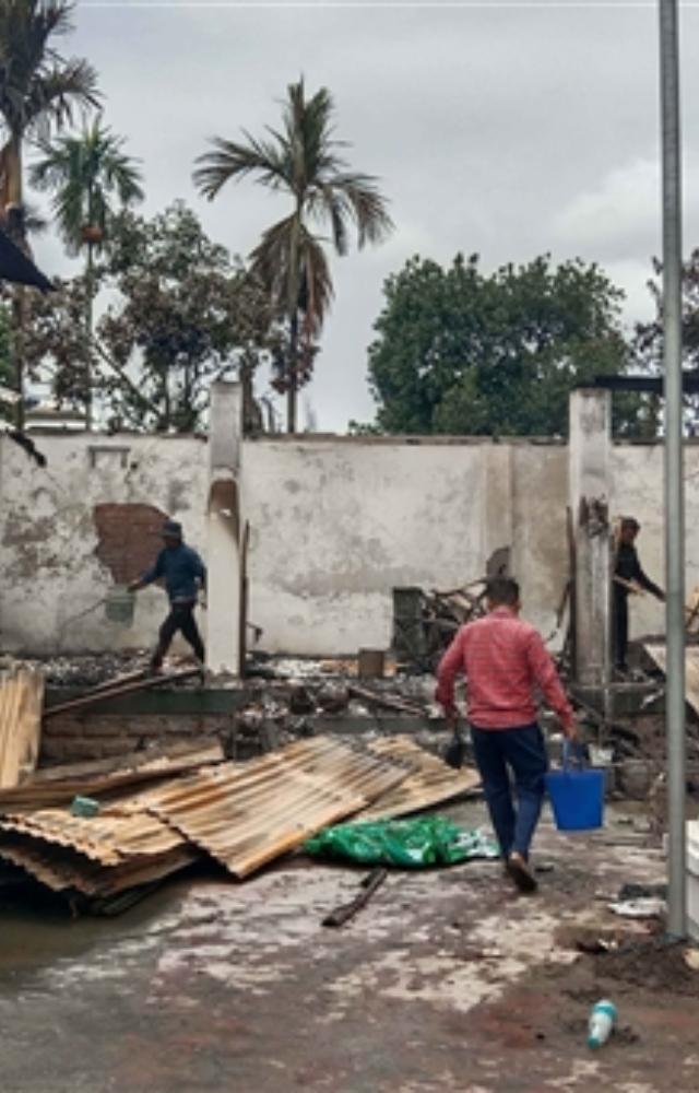 Workers attempt to salvage burnt items