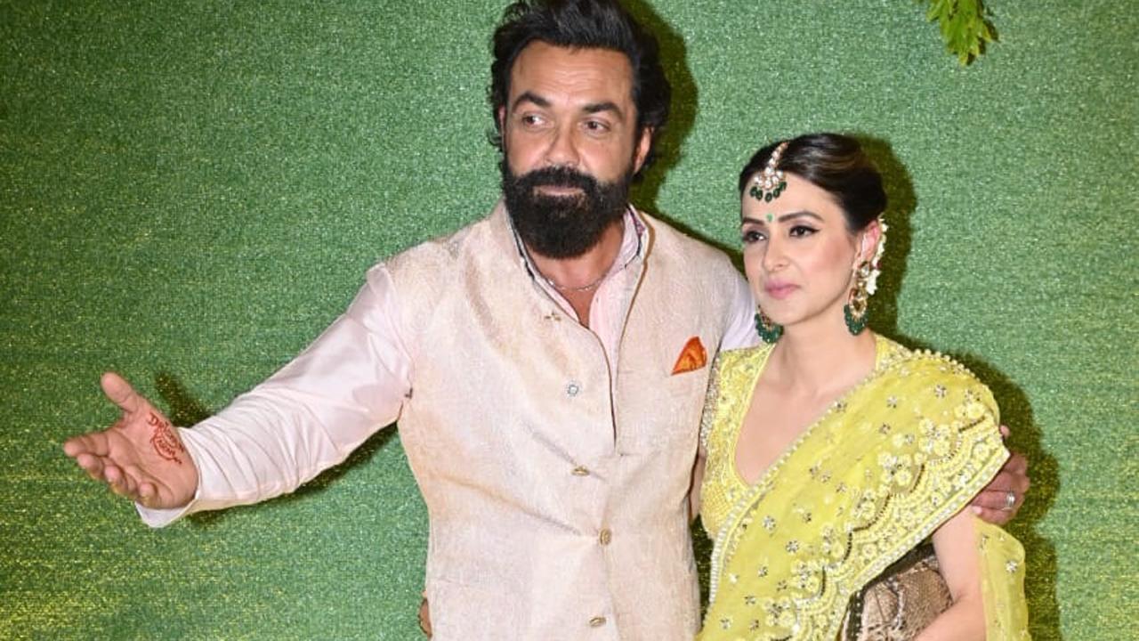Uncle of the groom Bobby Deol arrived with wife Tanya and posed for the paparazzi.