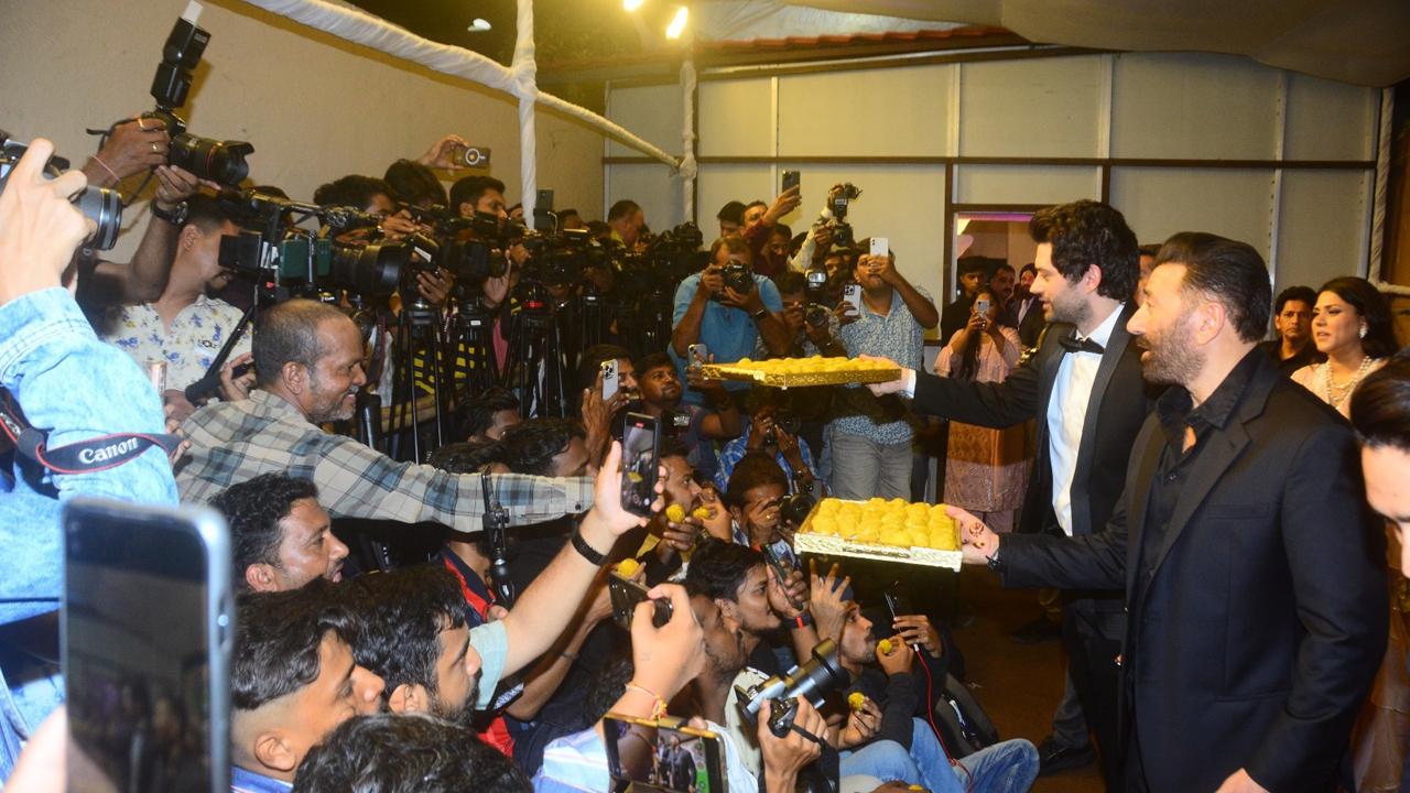 Rajveer and dad Sunny Deol distributed sweets to the media.