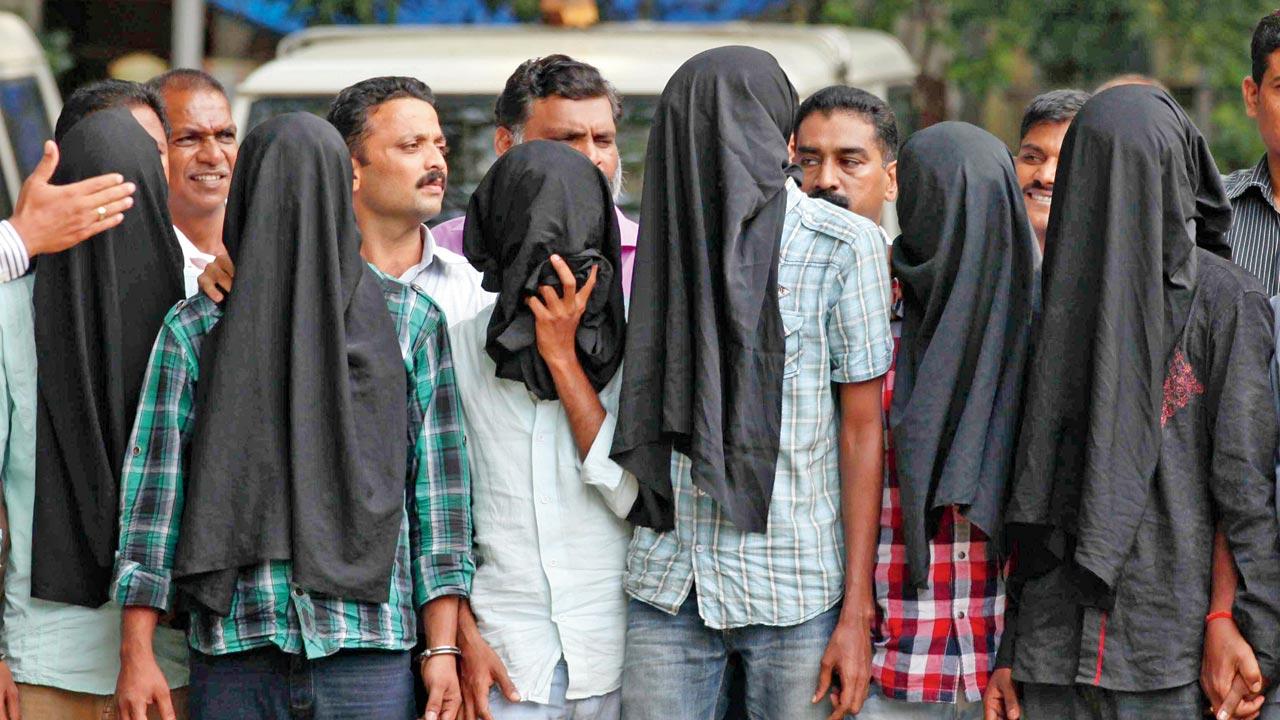 A file photo of the police parading six of the seven accused who were hired to shoot Dey, at the Mumbai Commissioner of Police office. Pic/Getty Images