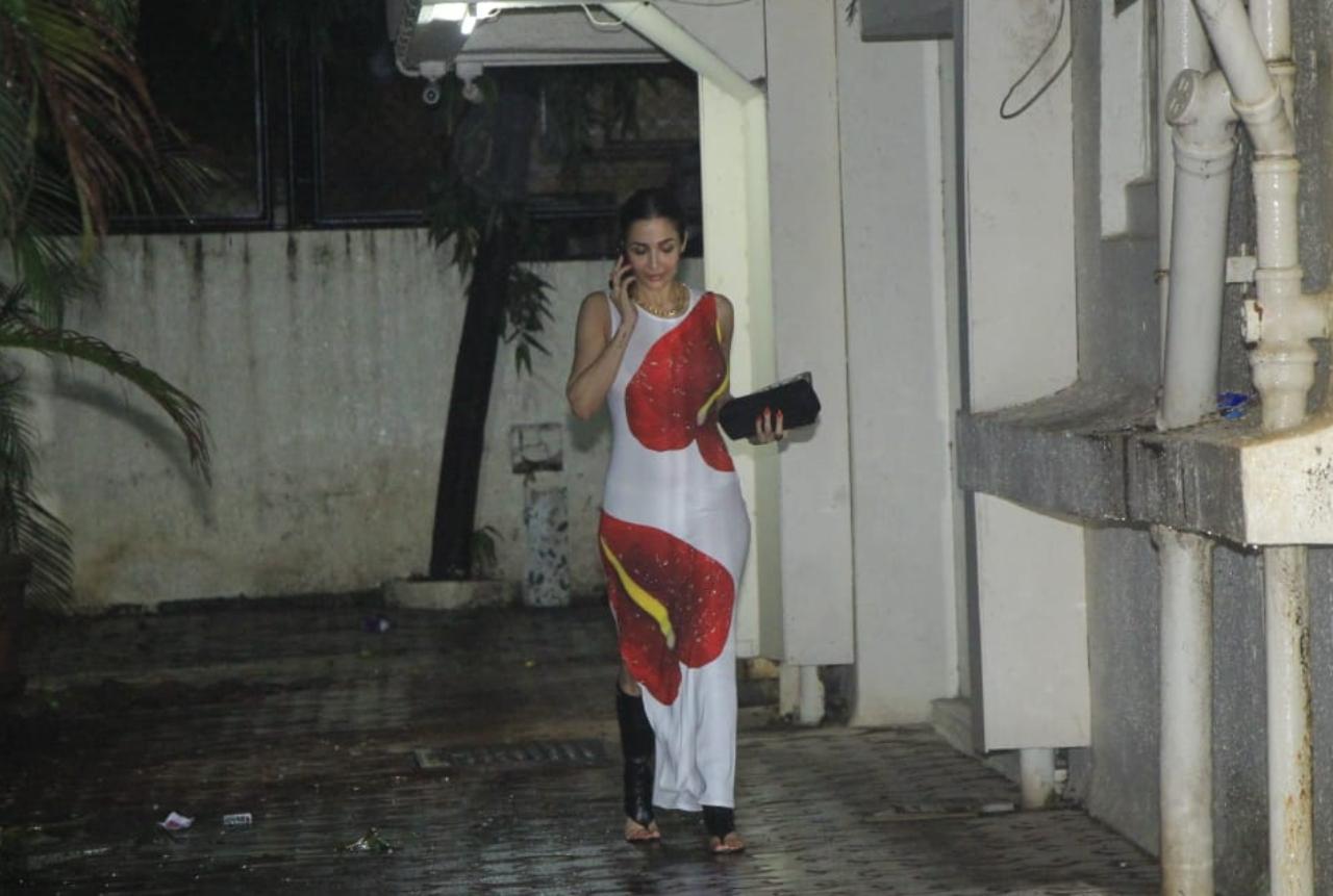 Malaika Arora was also spotted at Arjun's residence. She was dressed in a white bodycon dress with red prints