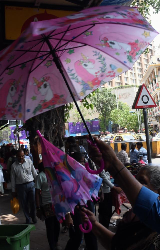 A woman scrutinises the strength of an umbrella at a shop in Dadar. PIC/ASHISH RAJE
