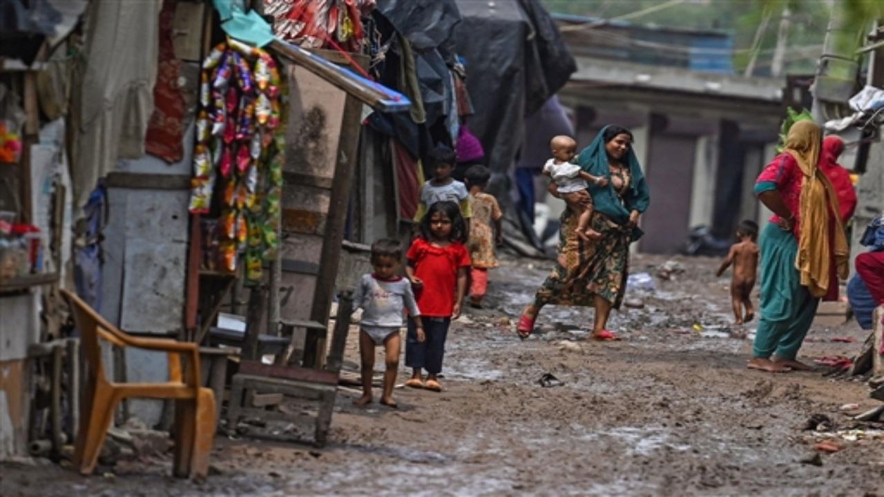 Rohingya refugees walk along a muddy street at a refugee camp on the World Refugee Day, in New Delhi on June 20, 2023. Photos/Agence France-Presse