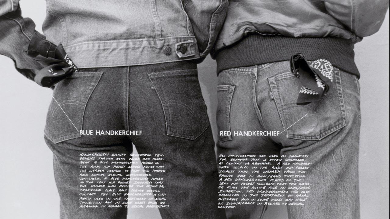 An image from Gay Semiotics (1977) by Hal Fischer featuring the blue handkerchief and red handkerchief codes used to denote “top” and “bottom” sexual preferences in the 1970s