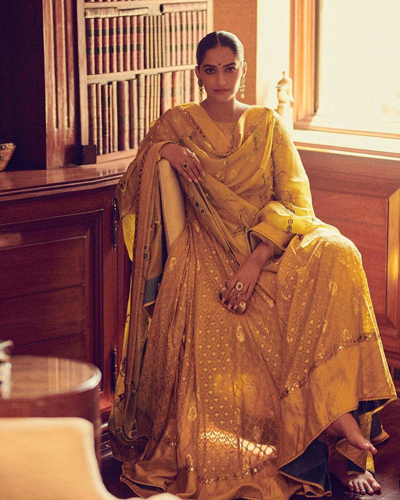 Dazzles in anarkali
From Western outfits to traditional ones, Sonam knows how to carry them with perfection. The actress looked stunning in yellow anarkali with a golden print. Along with it, she chooses a pink dupatta that was embellished with mirror work. She accessorised her ethnic style with dangling earrings and several gold rings