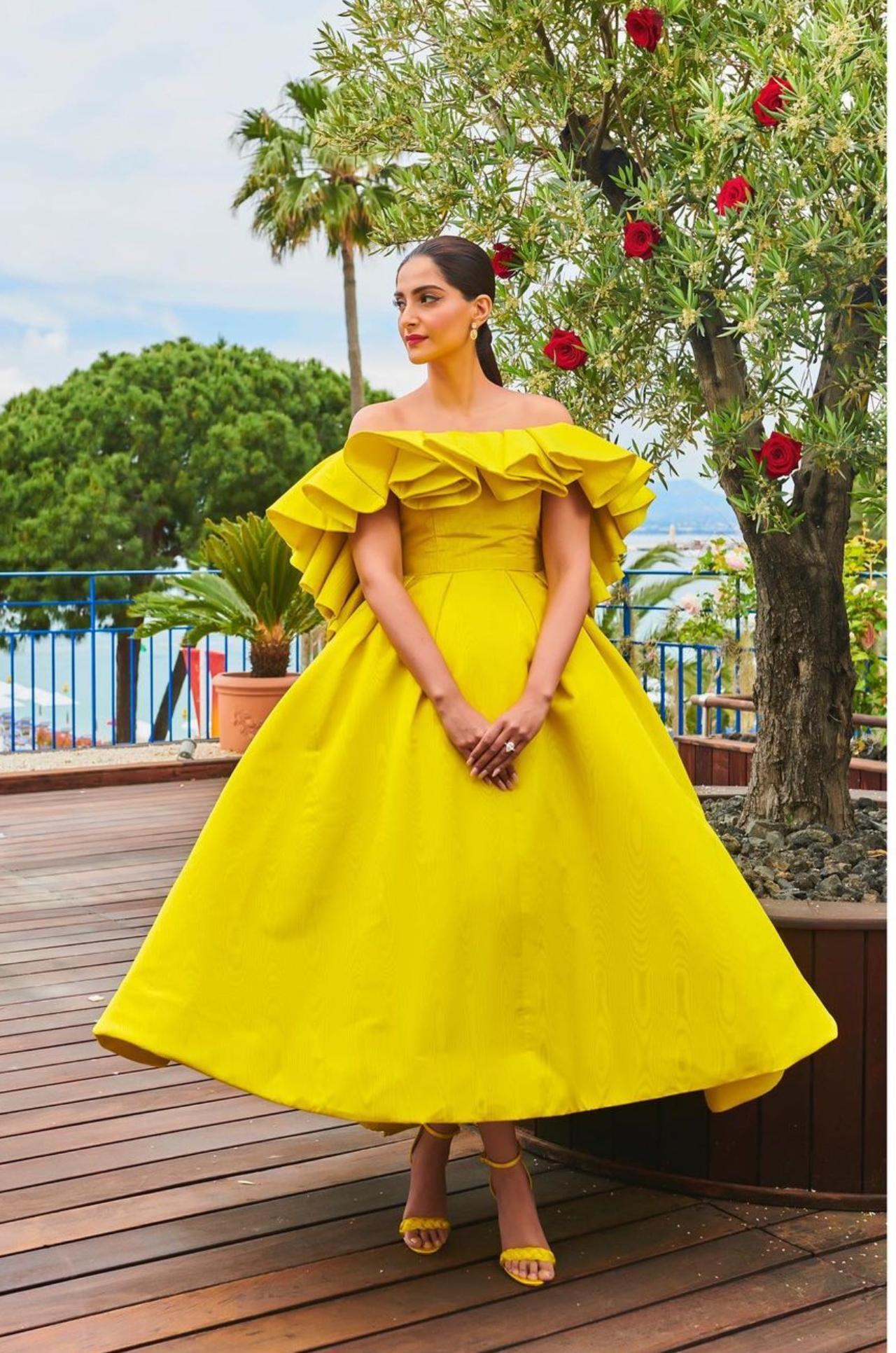 Shine in bright
Bright colours alone might sometimes be enough to boost an outfit. While slaying this vivid yellow dress with ruffles, Sonam proves this in the true sense