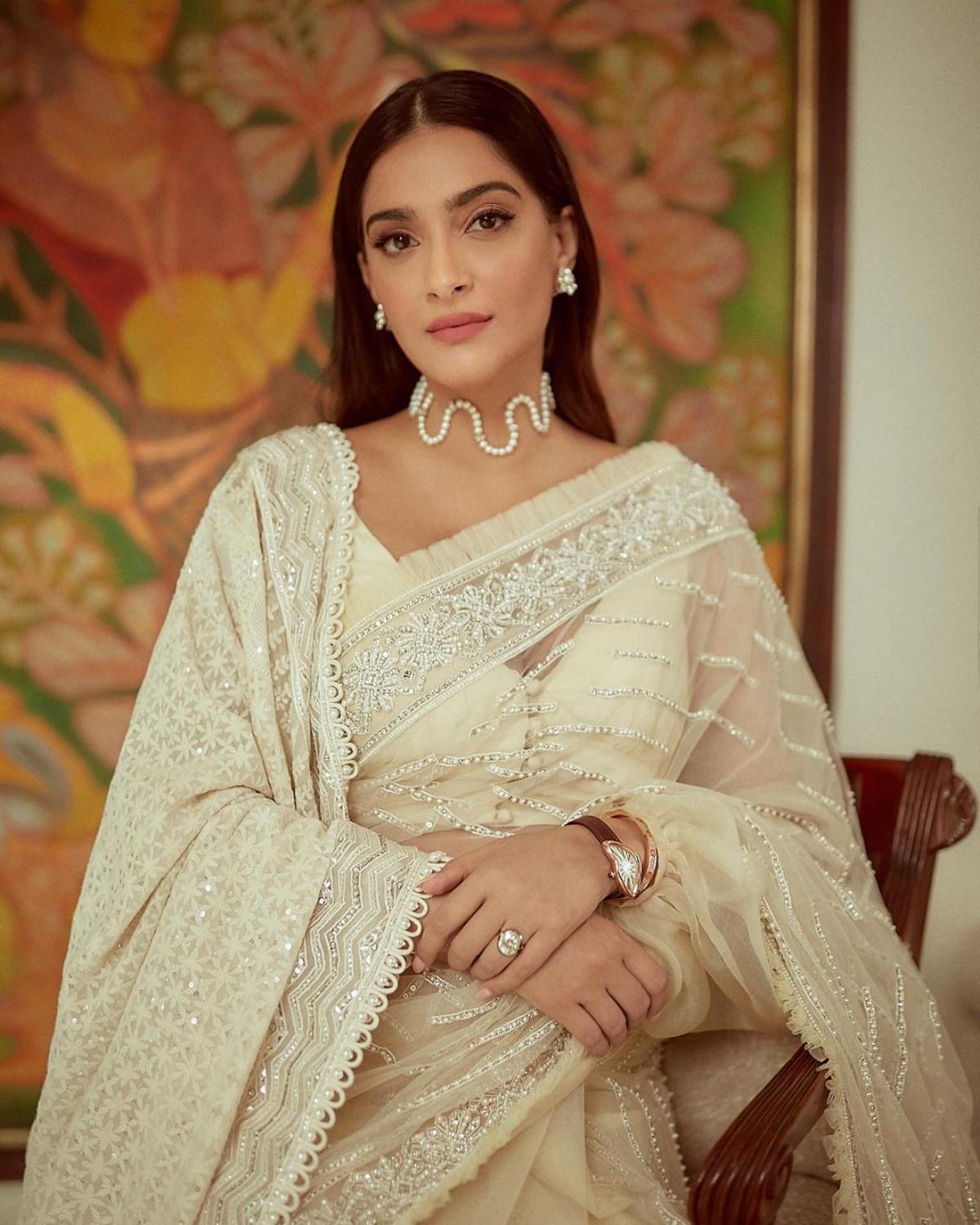 Pearly white: Sonam mesmerised everyone by dressing up in a pearl white sari with beautiful silver embroidery. She paired it with a white dupatta that had intricate white resham embroidery on one shoulder.