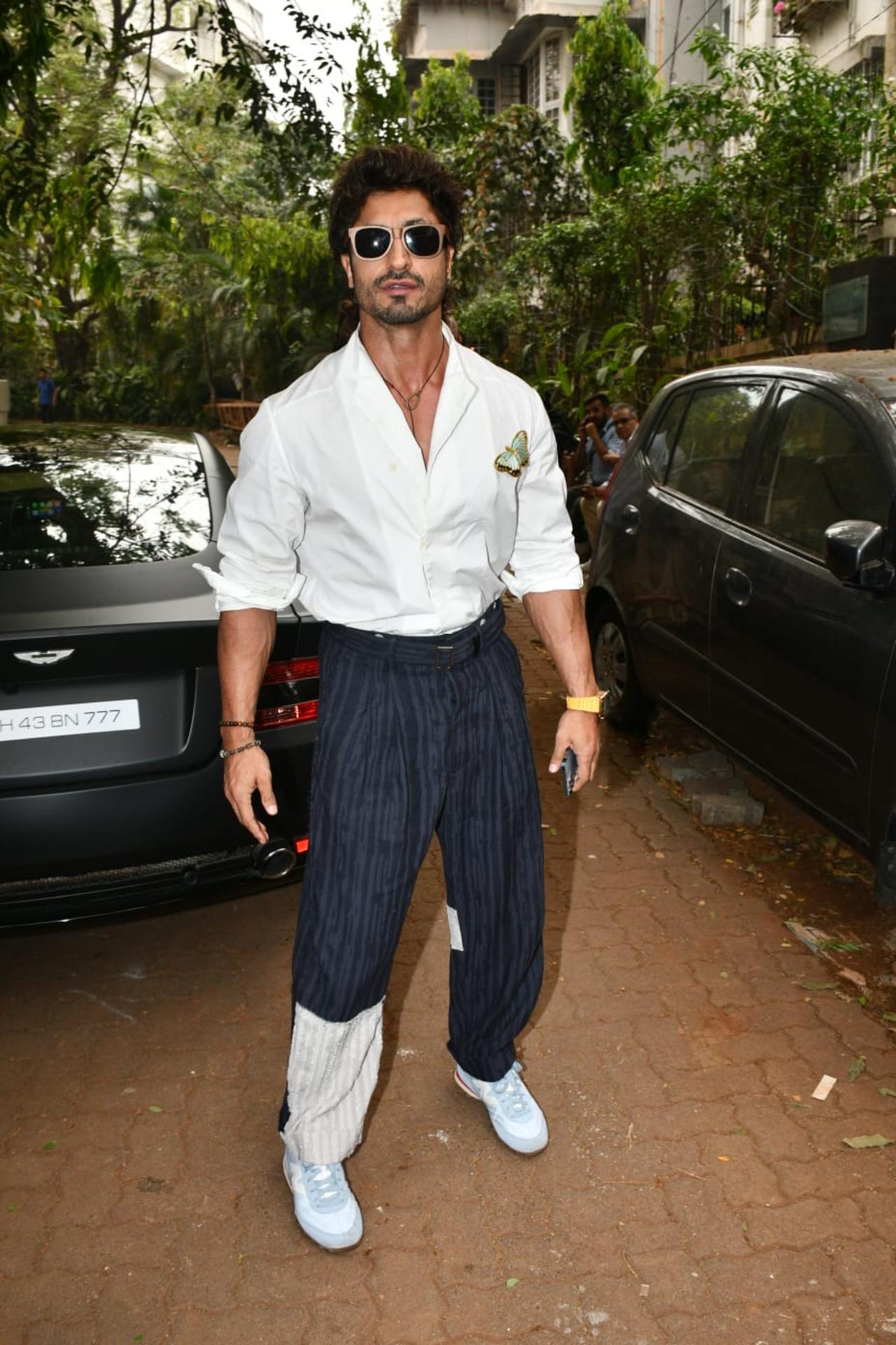 Vidyut Jammwal was in an experimental mood as the actor went for a white shirt, striped blue pants and white knee-length boots. He had black shades on and happily posed for the paparazzi
