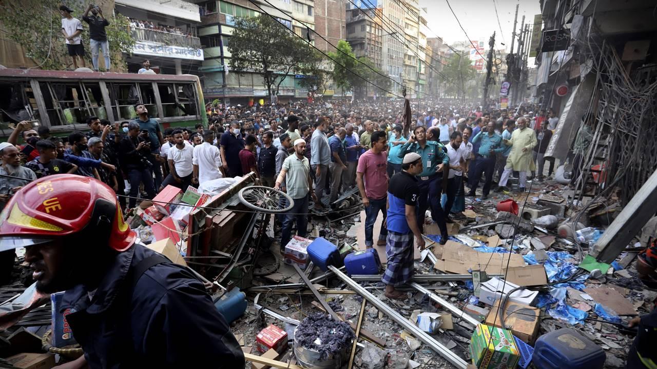 Onlookers gather outside the site of an explosion. Pic/AP