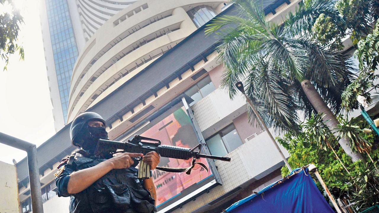 An armed policeman patrols the Bombay Stock Exchange building in south Mumbai on Saturday, on the eve of the 30th anniversary of the 1993 serial bomb blasts, that left 257 dead and over 800 seriously injured. Pic/Sayyed Sameer Abedi