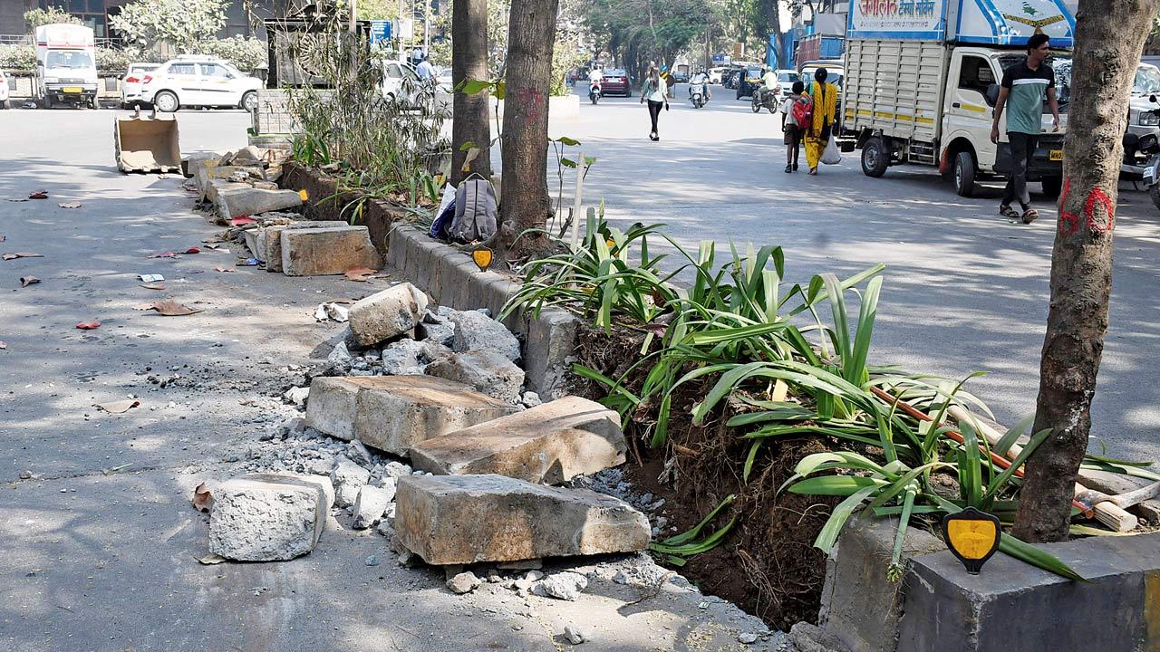 A divider being removed as part of the beautification drive at Jagat Vidya Marg, Bandra East. Pic/Ashish Raje
