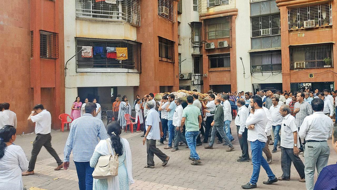 Shocked neighbours gather in the compound. File pics/Rajesh Gupta