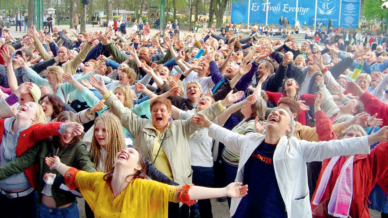Participants practise laughter at a yoga class in Denmark