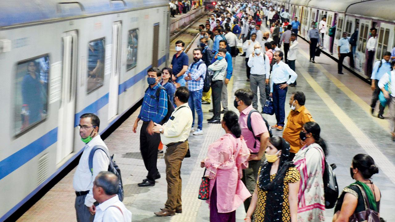 Passengers look on as an AC local train leaves CSMT. Pic/Ashish Raje