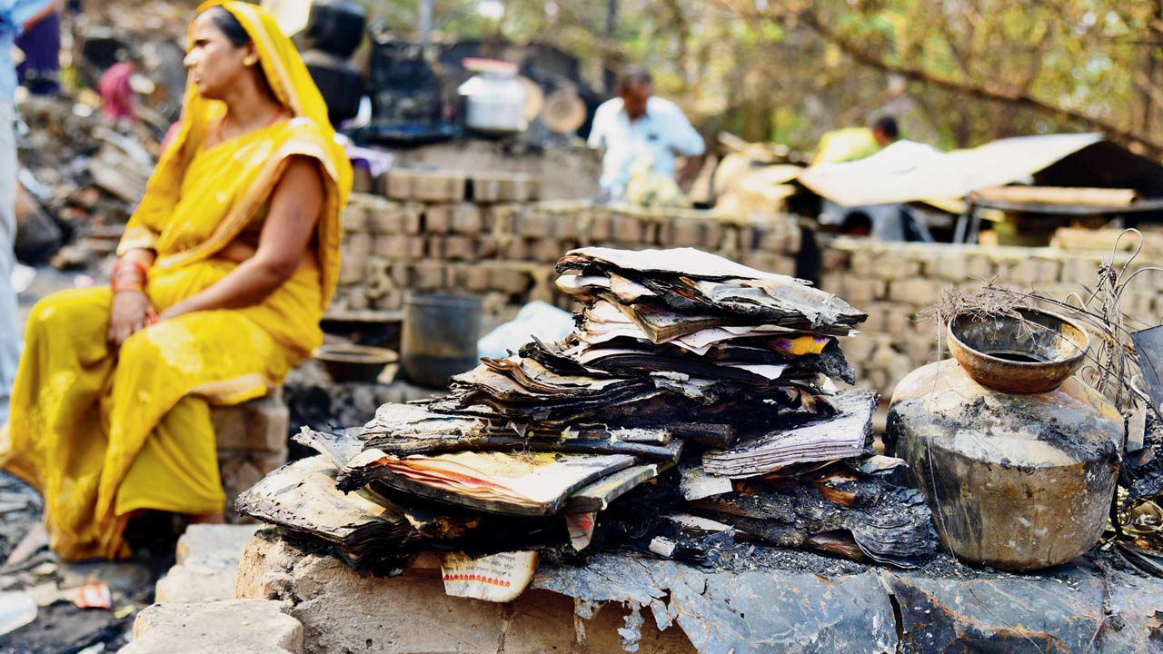 A local sits amidst the gutted remains. Pics/Nimesh Dave