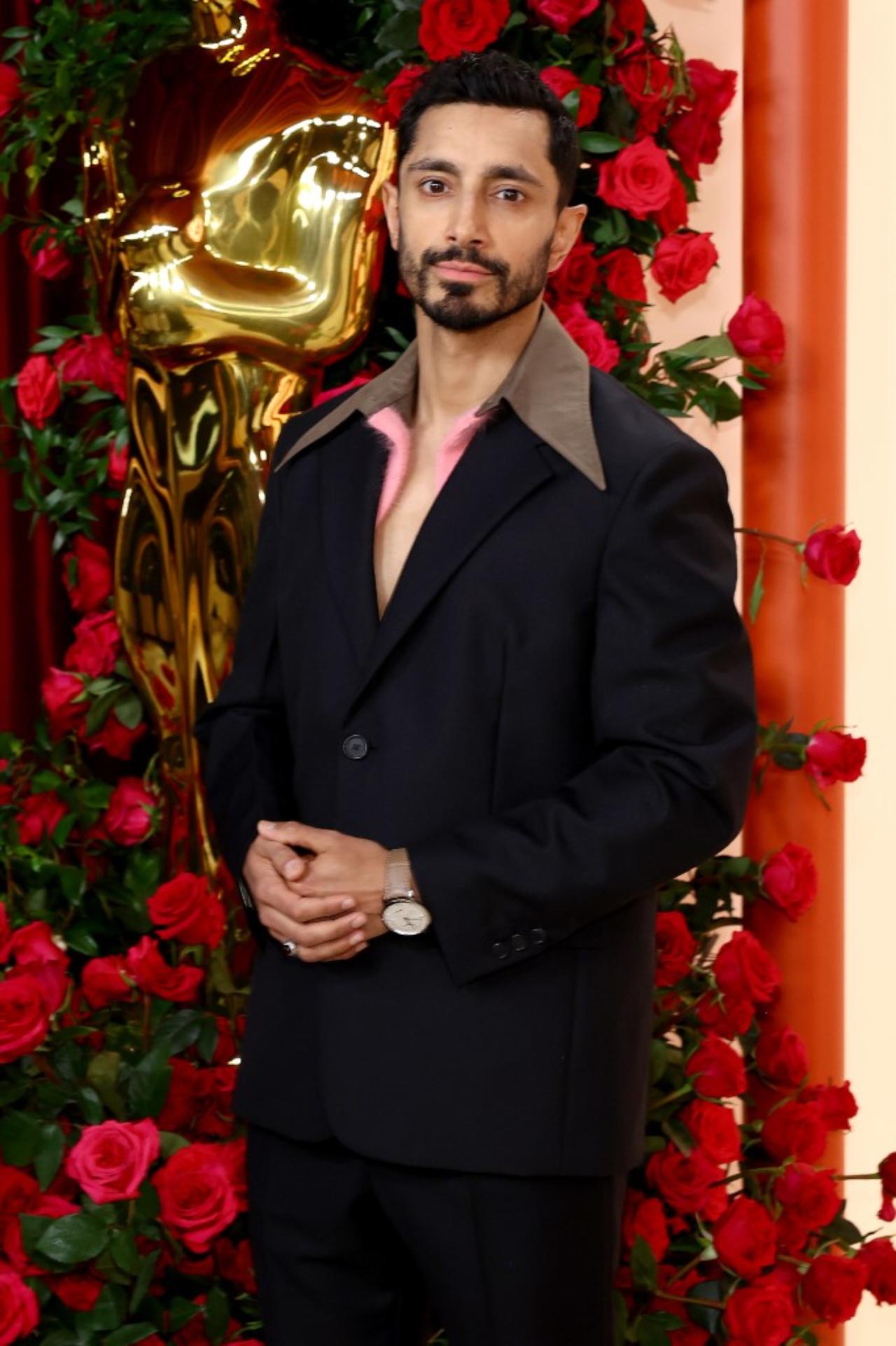 Riz Ahmed sported a black suit with a pink and brown collar at the 95th Annual Academy Awards