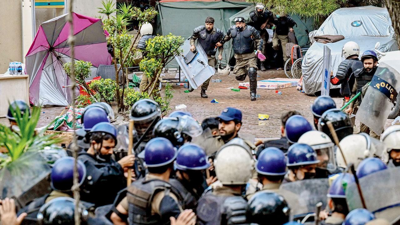 Riot police enter the residence of Khan in Lahore. Pic/AFP
