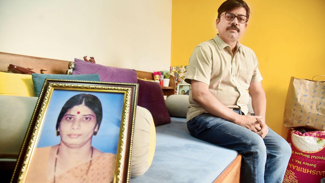 Tushar Deshmukh, who lost his mother in the blasts, next to her photograph in his Dadar residence. Pic/Shadab Khan