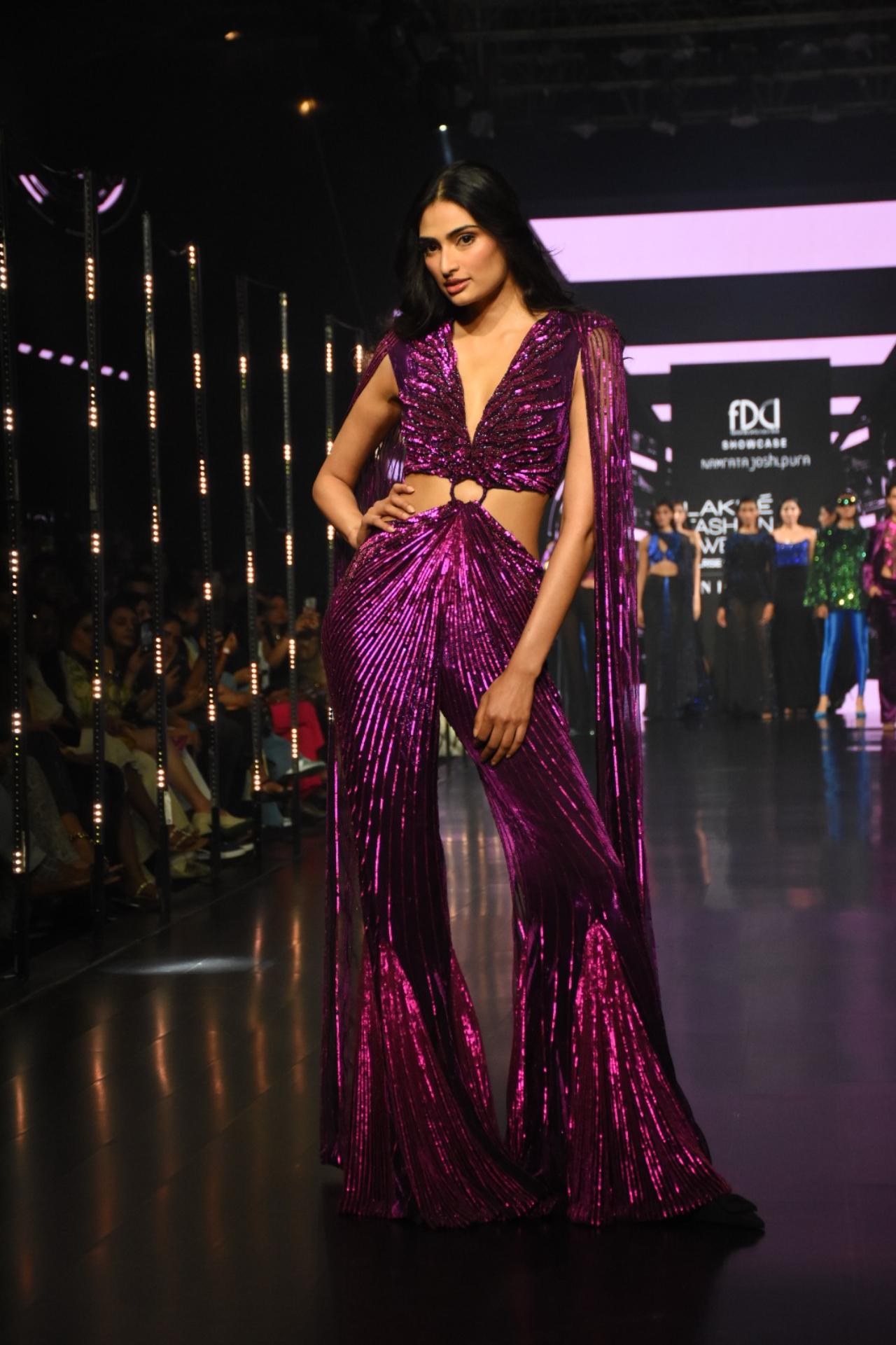 Bollywood actress Athiya Shetty stunned the Lakme Fashion Week ramp in a sparkly deep purple jumpsuit with matching trails on her shoulders. While the flared pants of the jumpsuit reverberated retro vibes, the 3D design of the outfit, gave the ensemble a modern feel. Athiya walked the runway as a show-stopper for designer Namrata Joshipura (Pic/ Yogen Shah)
 