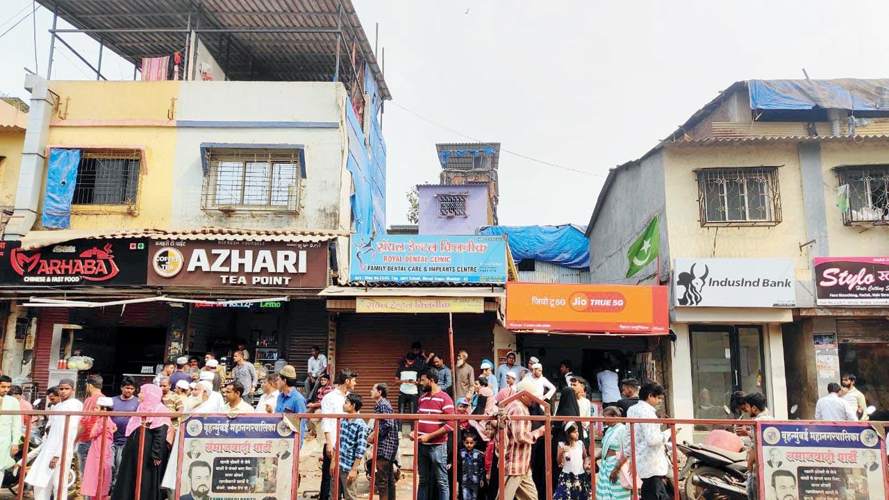 Commuters wait at the bus stop in Shivaji Nagar, Govandi 