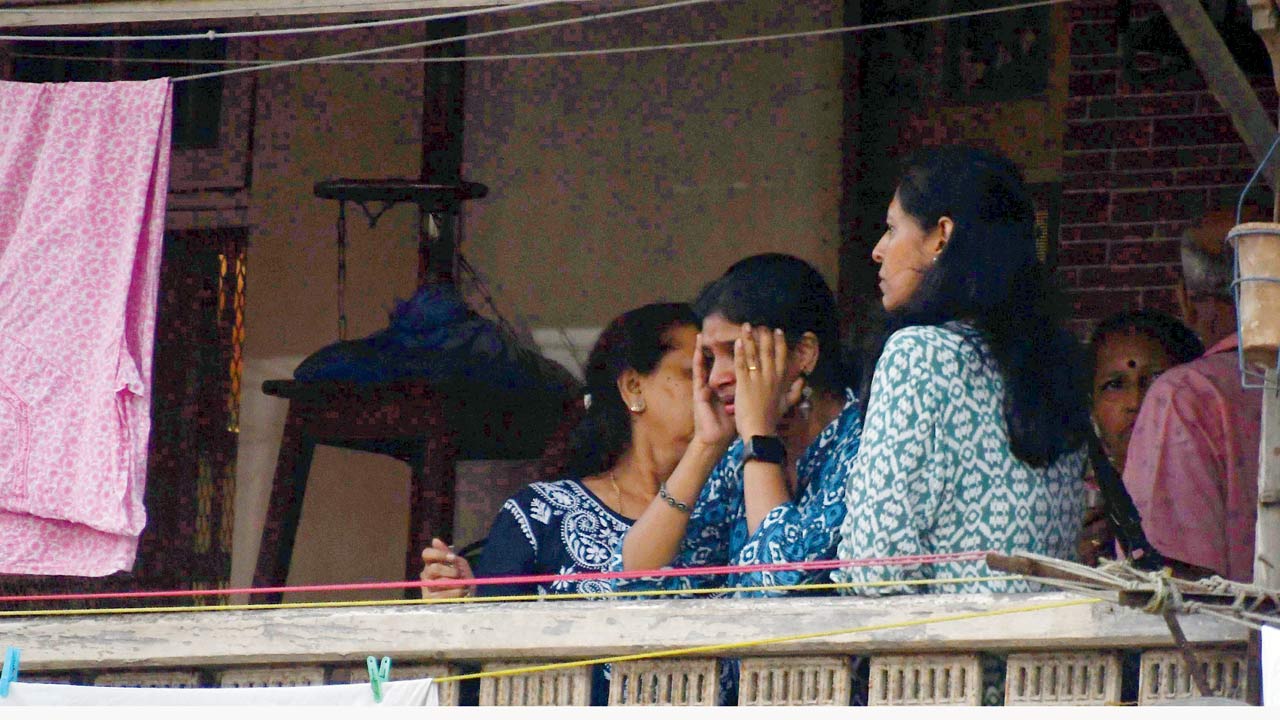 Distraught neighbours stand on the balcony of Parvati Mansion after the attack, in Grant Road, on Friday. Pic/Ashish Raje