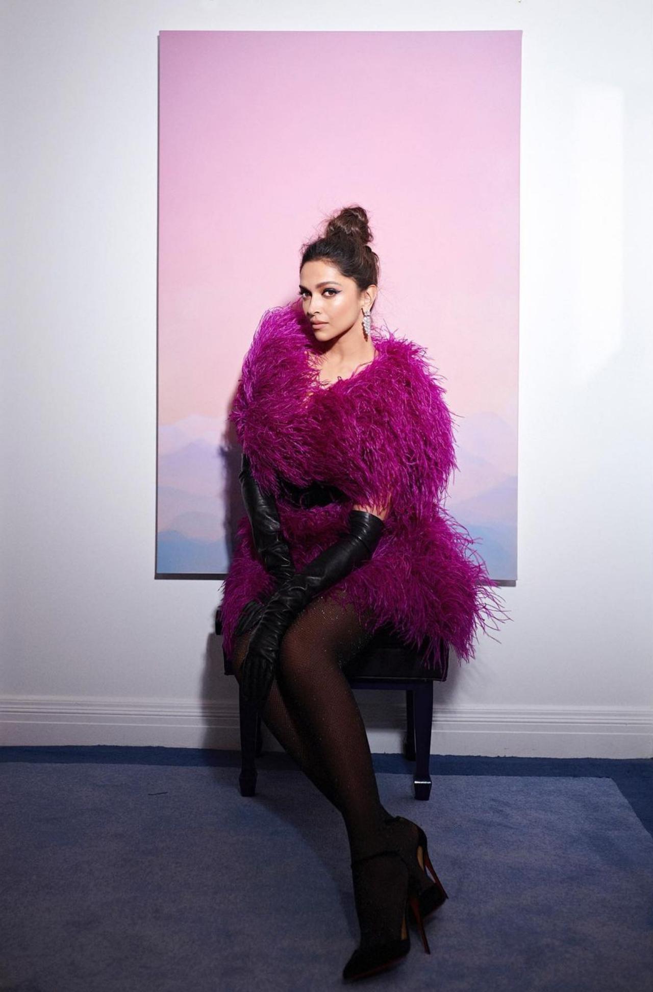 For the after-party look, Deepika opted for a magenta feather dress, which had the right pop of vibrancy. The dress was paired with long black leather gloves, black stockings and black pumps. The dress also consists of a black belt in the centre to cinch in the waist and give the dress a good silhouette. 