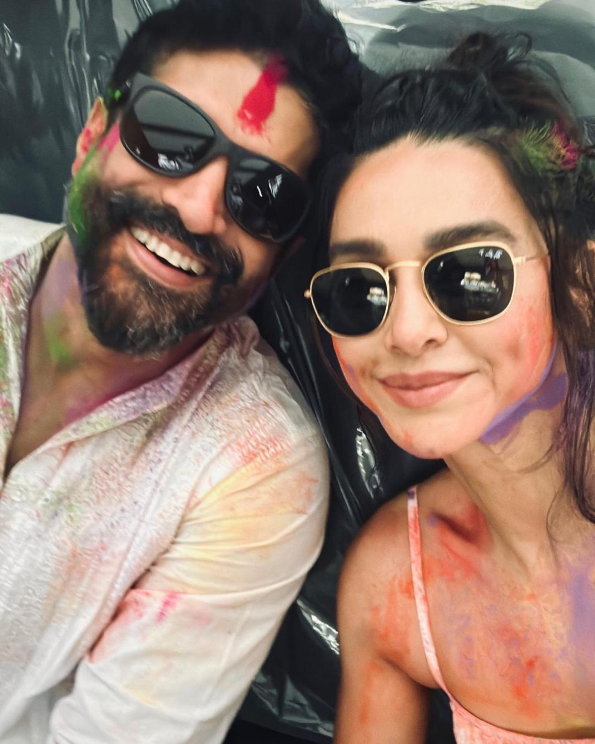 Another star couple of Bollywood, Shibani and Farhan Akhtar delighted their fans with a colourful selfie as they wished them on the occasion of Holi. In the photo, which was shared by Farhan's actor-wife, Shibani Akhtar on her official Instagram handle, the couple can be seen smeared in colours. With their sunglasses on, the couple looked super cool as they posed for the selfie with their innate swag. 