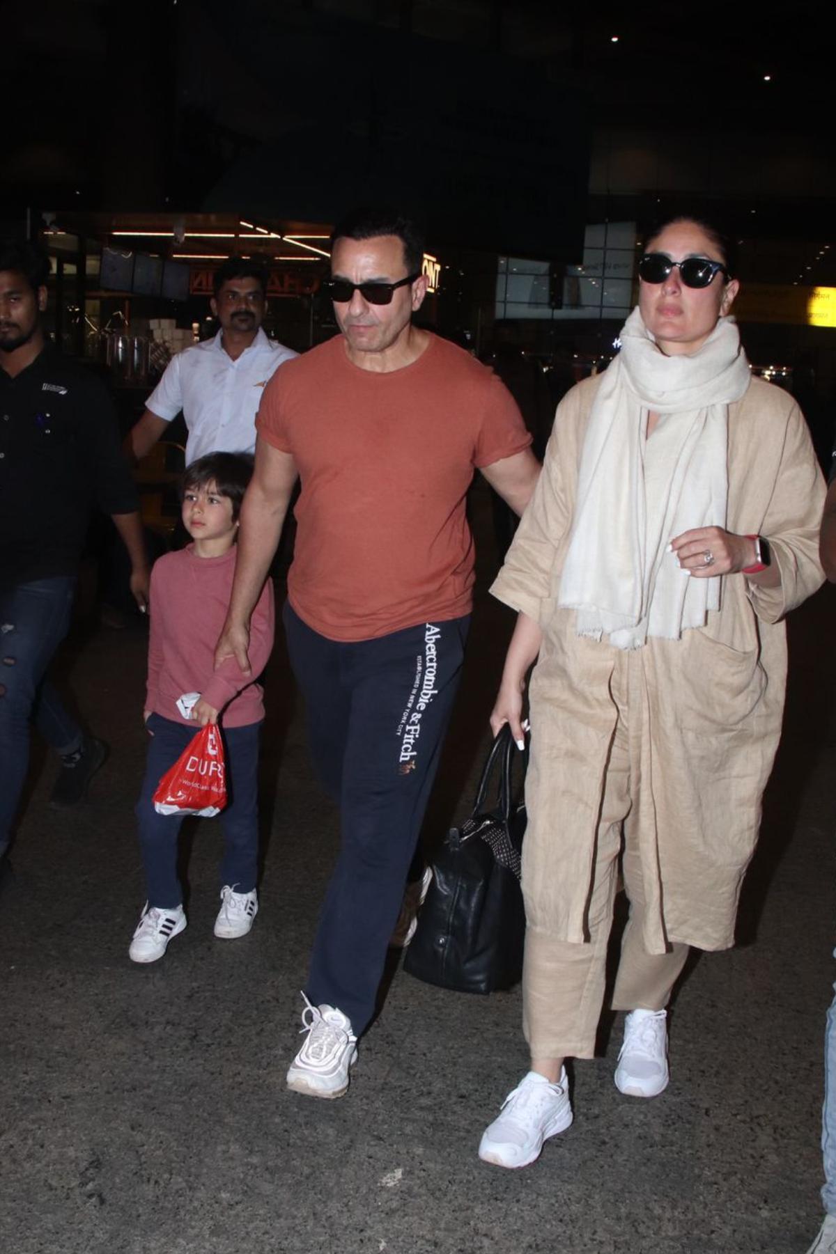 The family looked picture-perfect as they arrived at the airport in style. Kareena and Saif were accompanied by their adorable sons, Taimur and Jehangir, lovingly known as Tim and Jeh. While mommy Kareena walked out of the airport exuding all sass and glam, daddy Saif was seen holding the hand of little Tim while making an exit. 