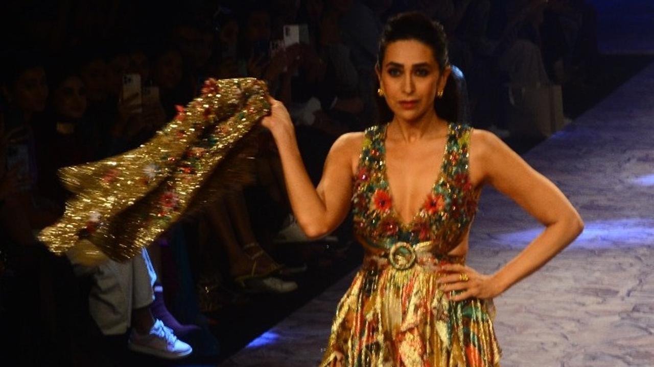 Karisma Kapoor took to the ramp to showcase a creation by designer Ranna Gill. The actress looked stunning in her golden embelished gown. 
