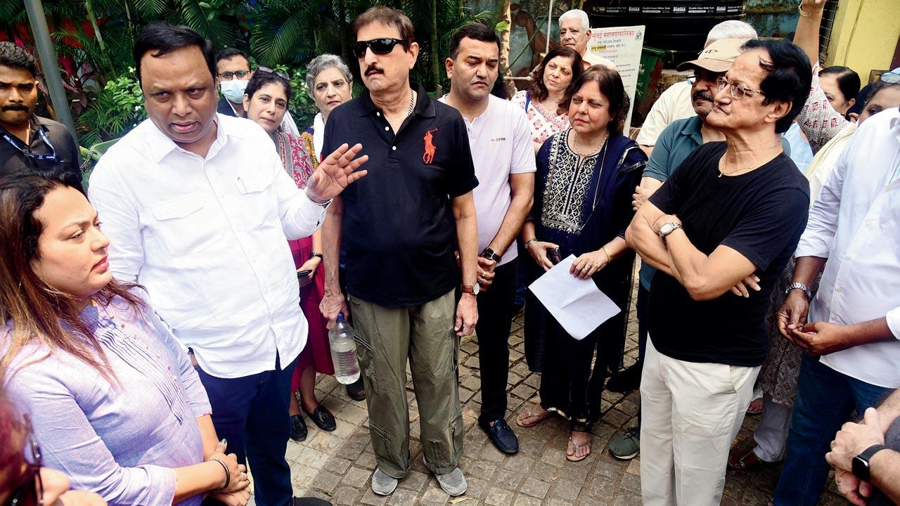 MLA Ashish Shelar speaks to residents of Tata Blocks, at Sadhu Vaswani Udyan, on Sunday. Pic/Shadab Khan