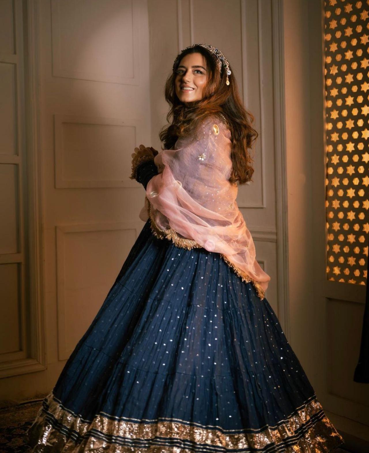Anarkali Suit
Here, Dogra is seen wearing a traditional Jammu purple Anarkali inspired by her cultural roots. She paired it with a heavy silver oxidised tiara headband with heavy earrings.