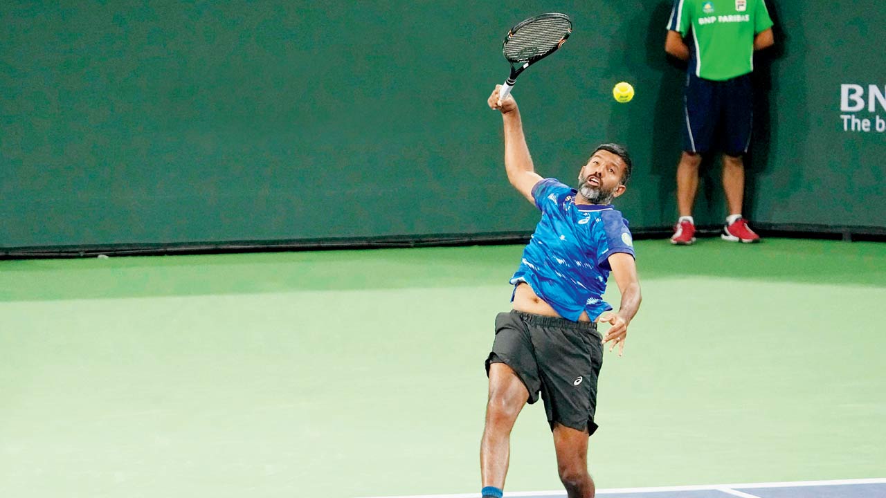 Rohan Bopanna makes an overhead return during the men’s doubles final at Indian Wells on Saturday.  Pics/AP, PTI