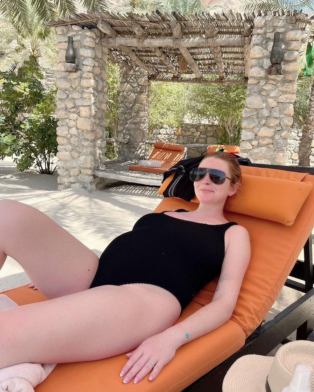 Actress Lindsay Lohan shared a photo of her baby bump as she lounged on a pool chair in a swimsuit. The 36-year-old actress was certainly glowing in her latest Instagram snap in which she relaxed on a sun lounger in a classic black swimsuit.