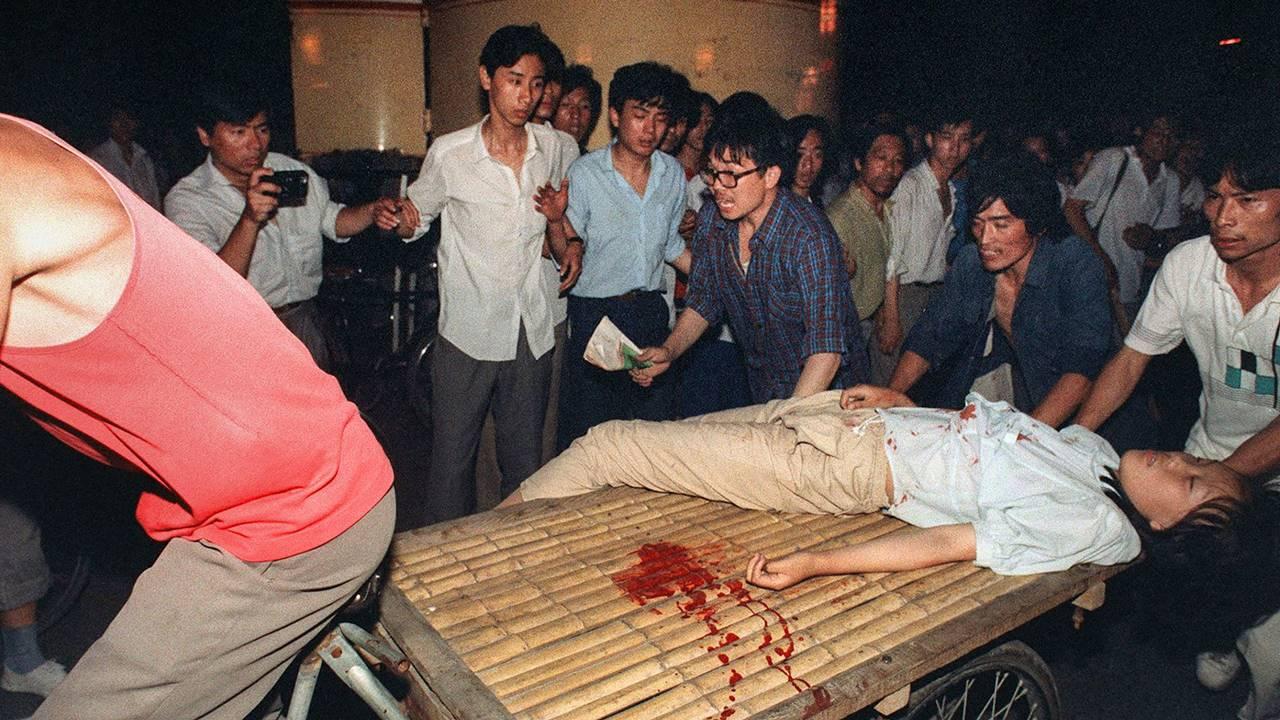  A woman wounded during a clash between the army and students holding pro-democracy protests is carried on a cart near Tiananmen Square in Beijing on June 4, 1989.