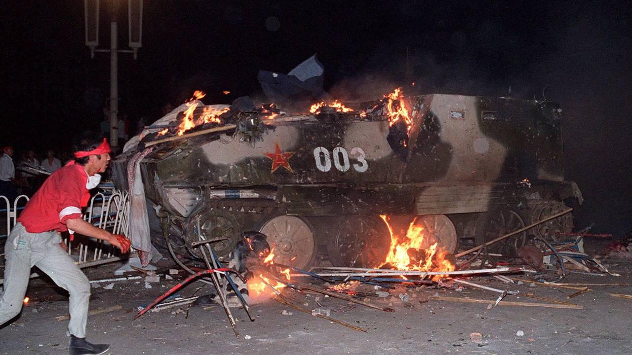 Pro-democracy protesters set an armoured personnel carrier on fire during a crackdown by authorities on the demonstrations near Tiananmen Square in Beijing on June 4, 1989.