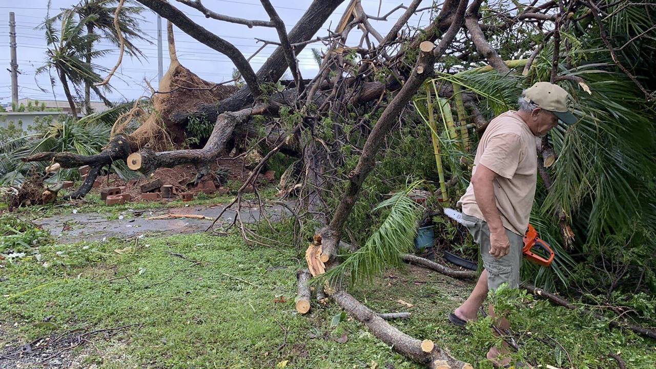 Andy Villagomez clears what remains of a large tree that overshadowed his front yard before falling to Typhoon Mawar, Thursday, May 25, 2023, in Mongmong-Toto-Maite, Guam. Pic/AP