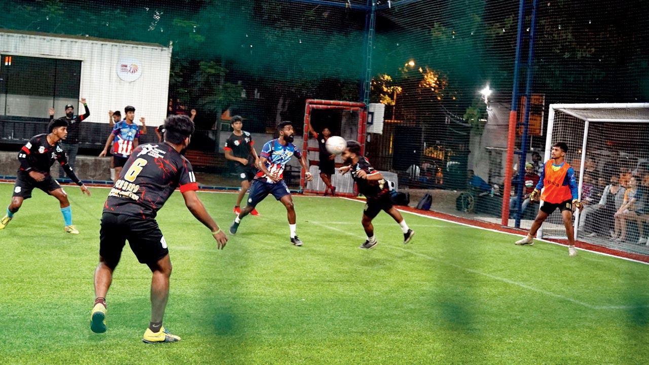 A player heads the ball away to defend his goal during a match 