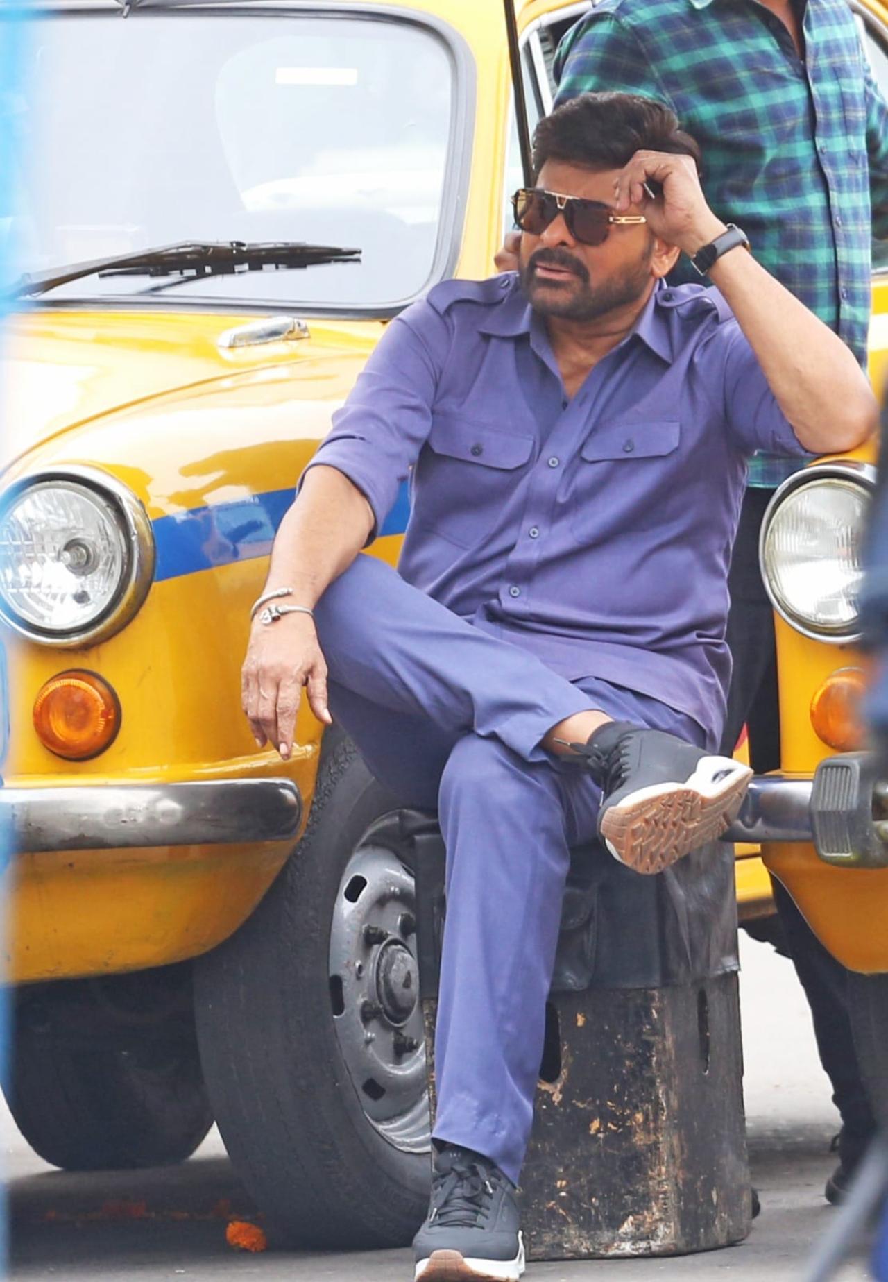 Chiranjeevi was seen in a grey taxi driver outfit and was seen roaming in front a fleet of taxis