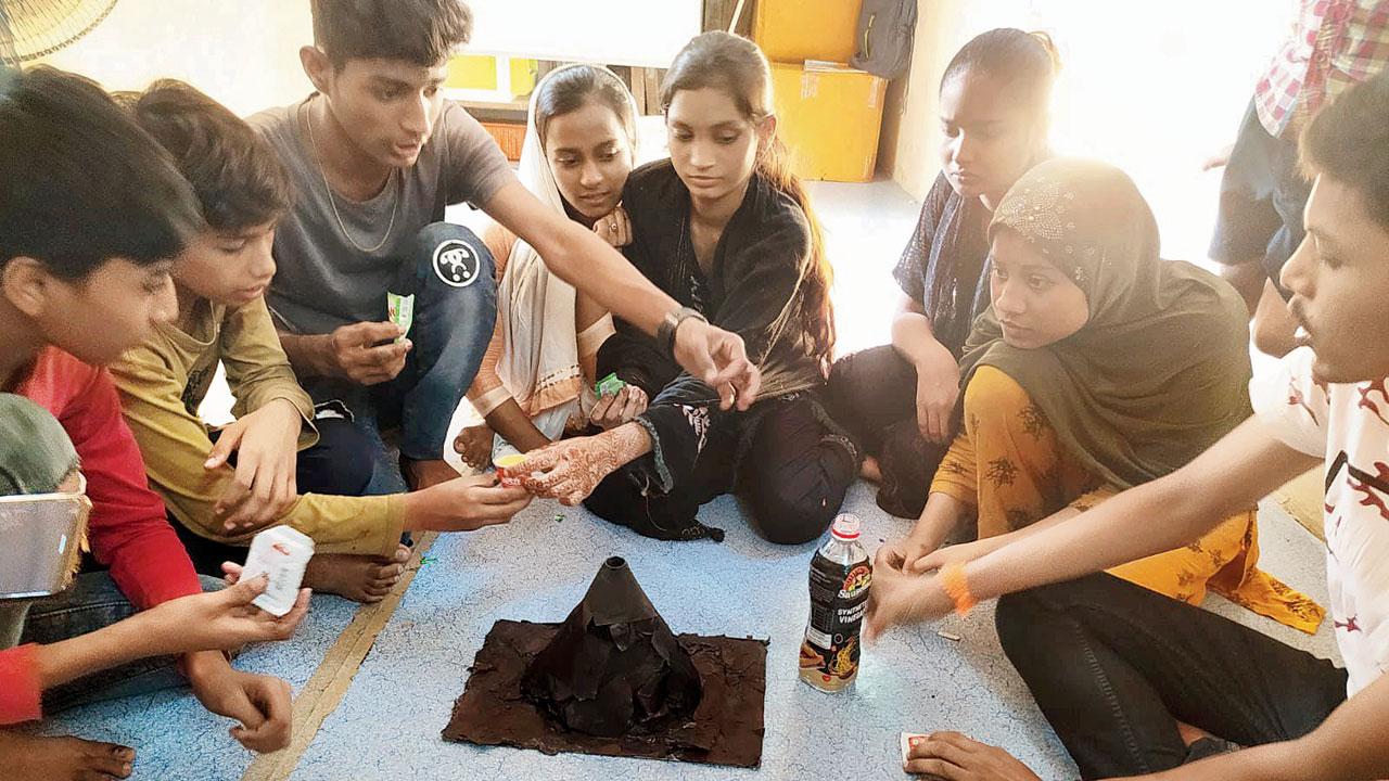 Children work on a volcano experiment