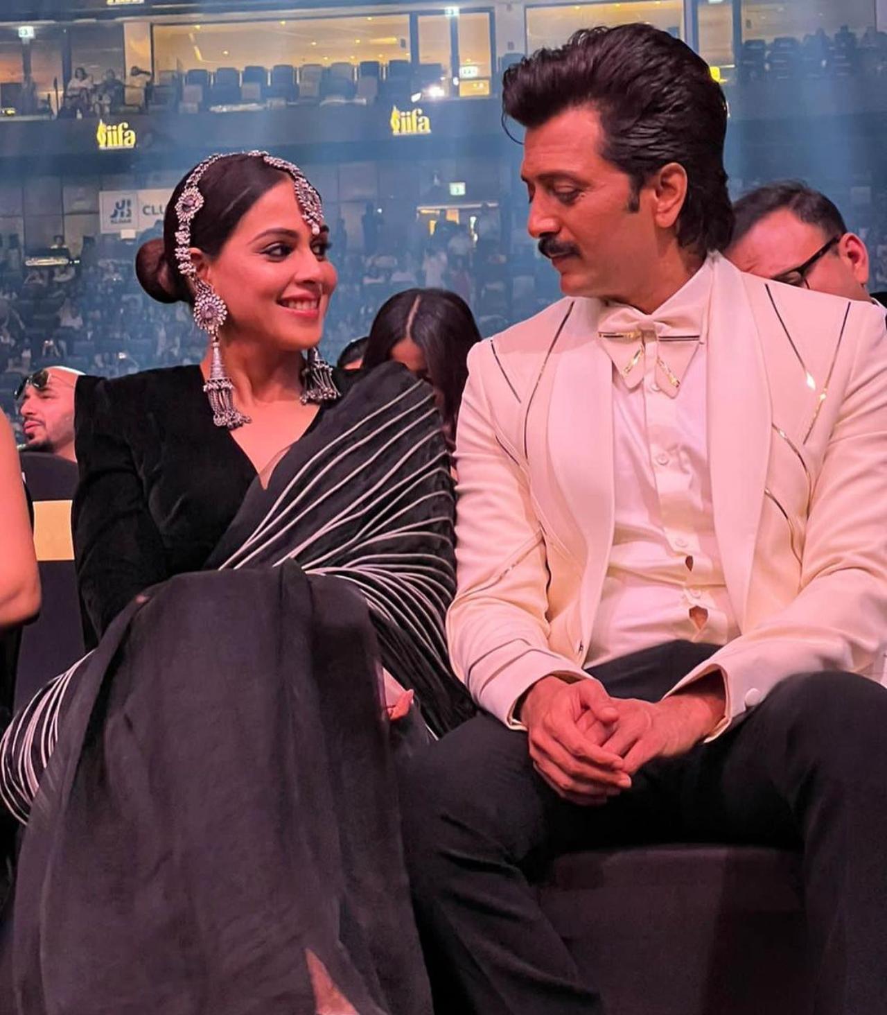 Riteish Deshmukh and Genelia Deshmukh won the award for Outstanding Achievement in Regional Cinema. The couple complimented each other in white and grey outfits. Here, the couple was captured in a candid moment as they enjoyed the show as an audience