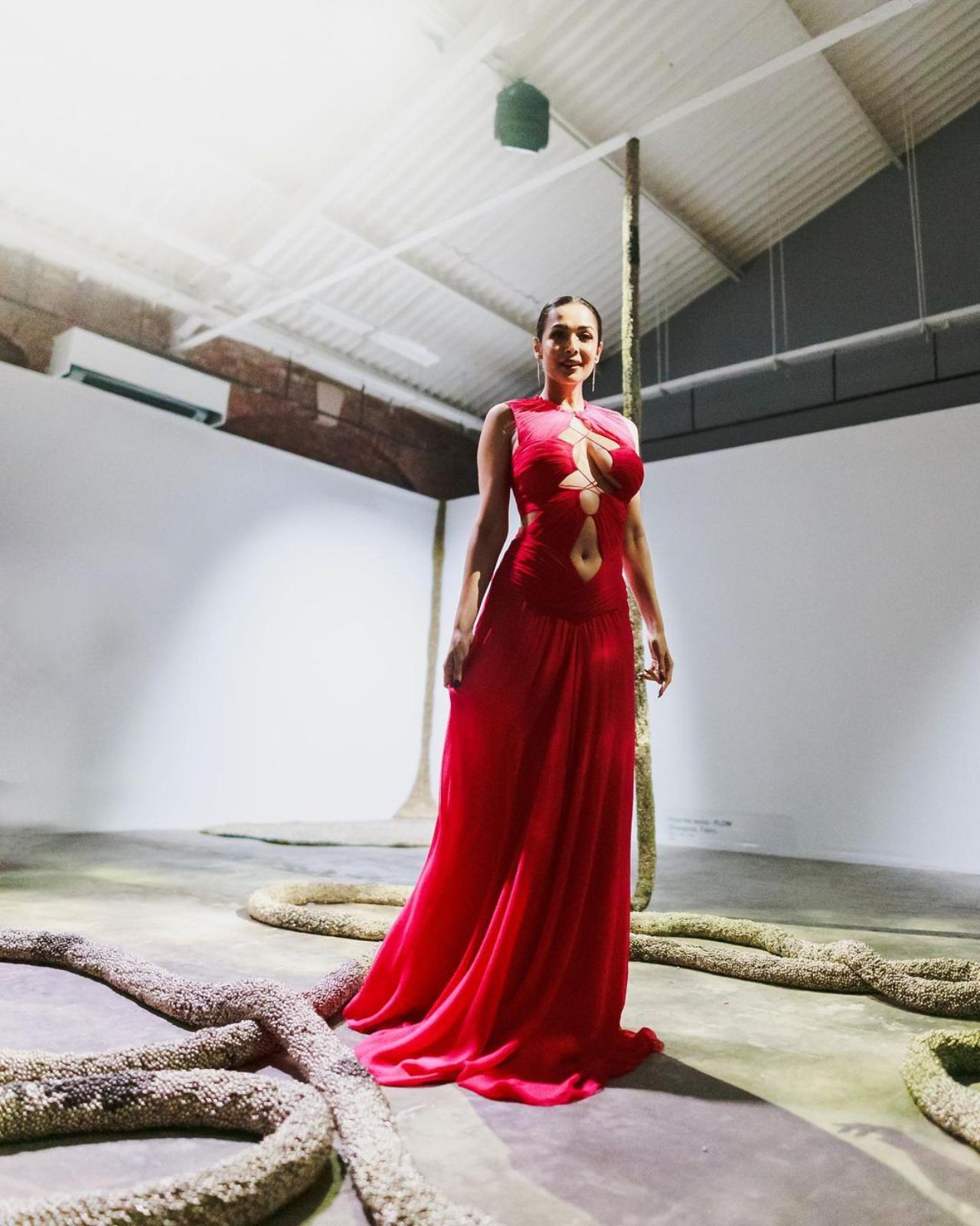 The actress sizzled on the red carpet in a breath-taking fiery red maxi dress with flattering cuts along a plunging neckline.  She tied her hair into a neat bun and simply accessorised her look with silver earrings and glam make-up