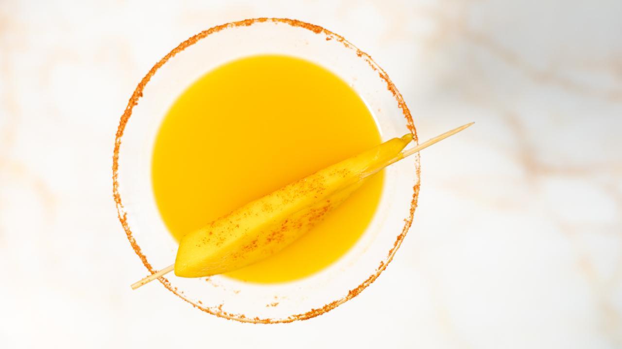 At Out Of The Blue, bartender Gaurav Prasad makes the Mangotini, a summer twist to the classic vodka martini. He makes it with vodka, mango puree, sweet and sour mix, ice, chilli and salt. Photo Courtesy: Out Of The Blue 