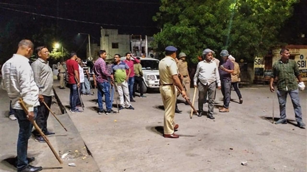 Police and other security personnel attempt to maintain law and order after a clash broke out between members of two communities over a social media post, in Akola Pic/PTI