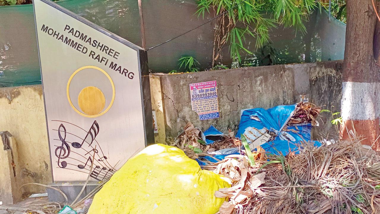 Heaps of garbage piled up next to the signage at Pali Hill