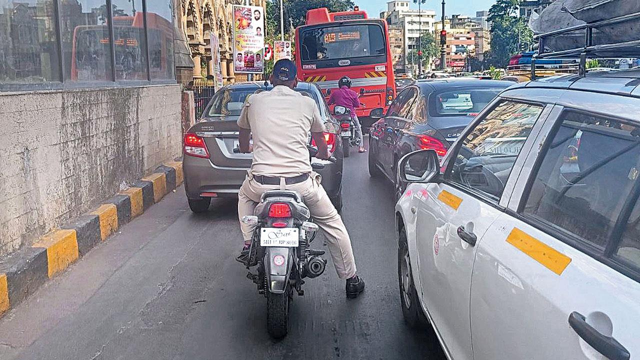 The photograph posted by Usman Patel, pointing at the helmetless policeman. Pic Courtesy/Twitter