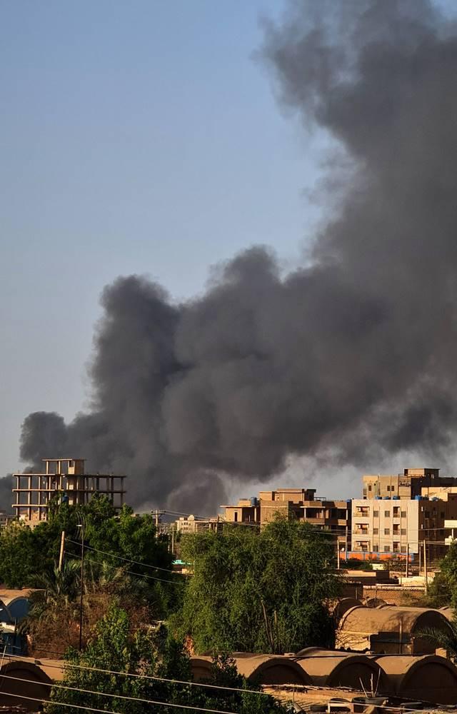Smoke rises above buildings in Khartoum, as violence between two rival Sudanese generals continues, on May 17, 2023.